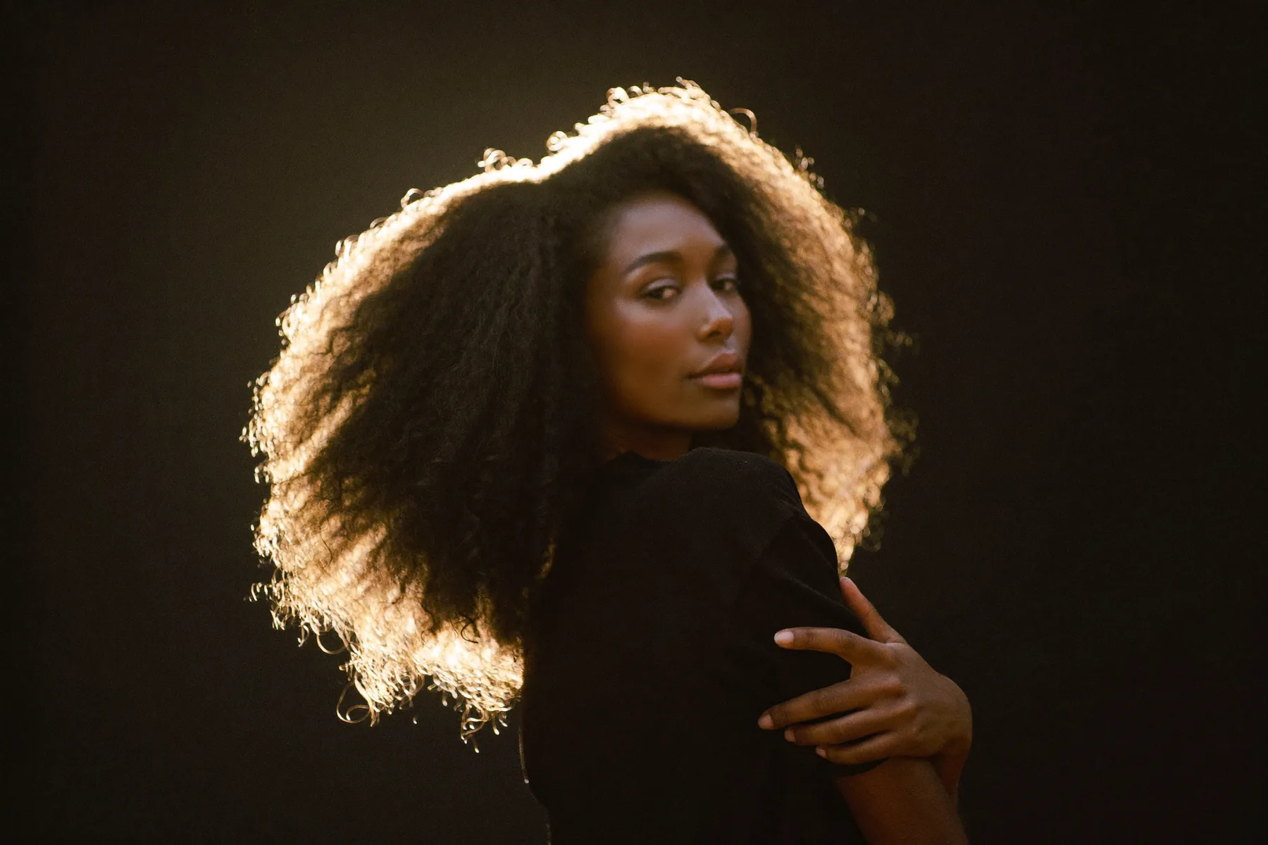 Priss Kay, dense natural hair in warm golden light